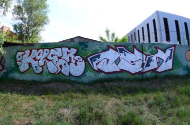 Sokak sanatı. Arka plan görüntüsü tam tamamlanan grafiti resmi bulunan bir rahiplik krom dolgu, arka planı yeşil ve kırmızı özetliyor. Balıkgözü fotoğraf.