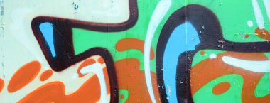 Sokak sanatı. Haki yeşil ve turuncu tonlarında renkli grafiti resmi bir parçasının arka plan görüntü.