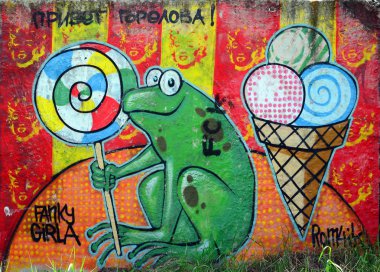 Sokak sanatı. Arka plan görüntüsü tam tamamlanan graffiti resim karikatür kurbağa ve lolipop.