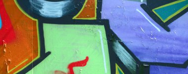 Sokak sanatı. Haki yeşil ve turuncu tonlarında renkli grafiti resmi bir parçasının arka plan görüntü.