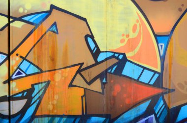 Sokak sanatı. Bej ve turuncu tonlarında renkli grafiti resmi bir parçasının arka plan görüntü.