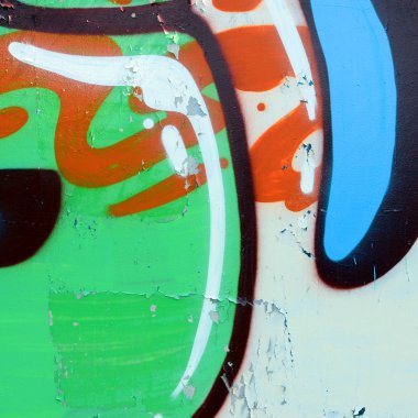 Sokak sanatı. Haki yeşil ve turuncu tonlarında renkli grafiti resmi bir parçasının arka plan görüntü.