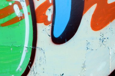 Sokak sanatı. Haki yeşil ve turuncu tonlarında renkli grafiti resmi bir parçasının arka plan görüntü.