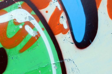Sokak sanatı. Haki yeşil ve turuncu tonlarında renkli grafiti resmi bir parçasının arka plan görüntü.