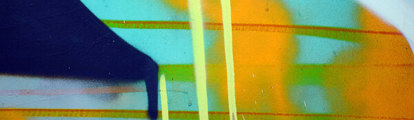 Street art. Abstract background image of a fragment of a colored graffiti painting in khaki green and orange tones.