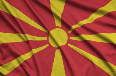 Makedonya bayrağı ile birçok çiziklere spor bez kumaş üzerinde tasvir edilmiştir. Spor takım sallayarak afiş