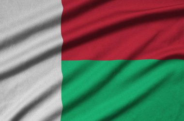 Madagaskar bayrağı ile birçok çiziklere spor bez kumaş üzerinde tasvir edilmiştir. Spor takım sallayarak afiş