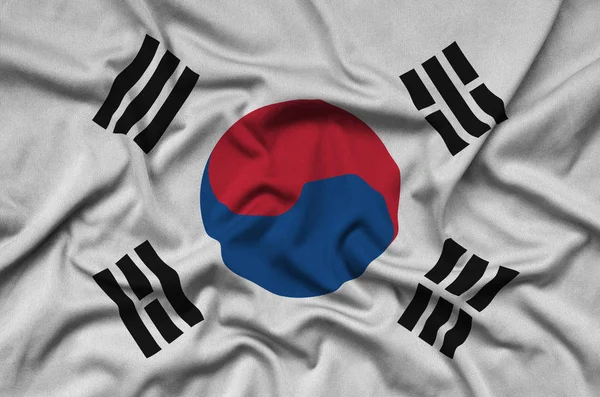 韩国国旗在运动布织物上描绘了许多褶皱 运动队挥舞旗帜 — 图库照片