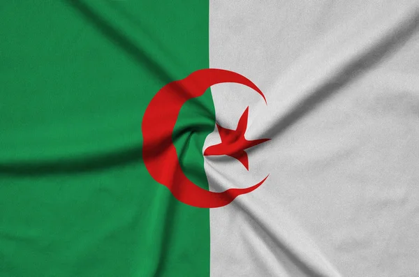 Algeria flag  is depicted on a sports cloth fabric with many folds. Sport team waving banner