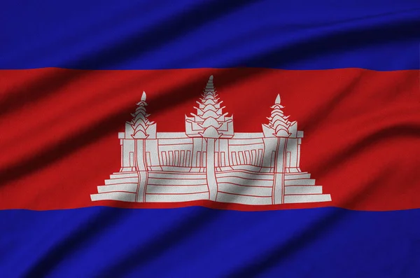 柬埔寨国旗描绘在一个运动布织物与许多褶皱 运动队挥舞旗帜 — 图库照片