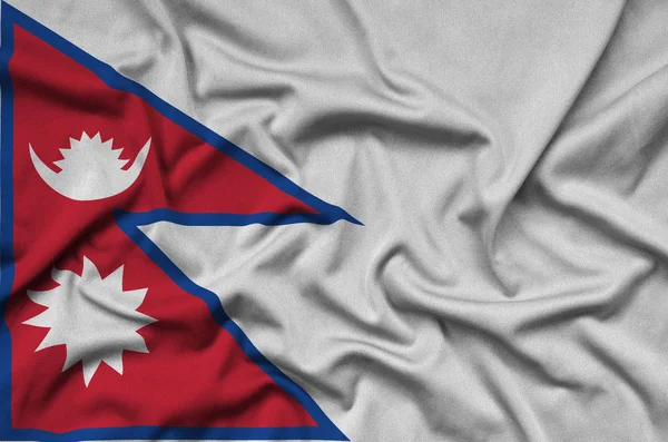 Nepal flag  is depicted on a sports cloth fabric with many folds. Sport team waving banner