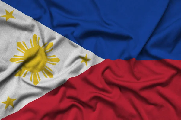 Philippines flag  is depicted on a sports cloth fabric with many folds. Sport team waving banner