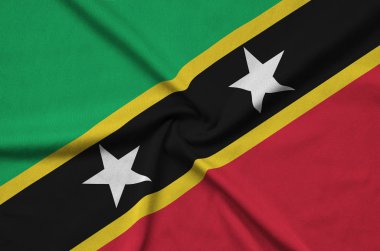 Saint Kitts ve Nevis bayrak birçok çiziklere ile spor bez kumaş üzerinde tasvir edilmiştir. Spor takım sallayarak afiş