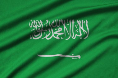 Suudi Arabistan bayrağı ile birçok çiziklere spor bez kumaş üzerinde tasvir edilmiştir. Spor takım sallayarak afiş