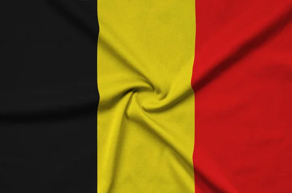 Belgium flag  is depicted on a sports cloth fabric with many folds. Sport team waving banner