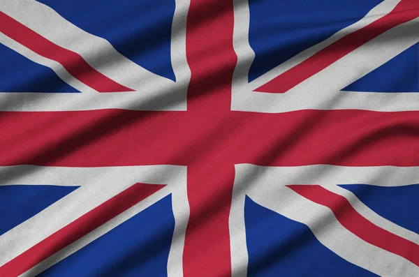 英国国旗被描绘在一个运动布织物与许多褶皱 运动队挥舞旗帜 — 图库照片
