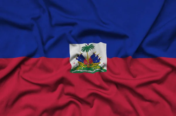 Haiti flag  is depicted on a sports cloth fabric with many folds. Sport team waving banner