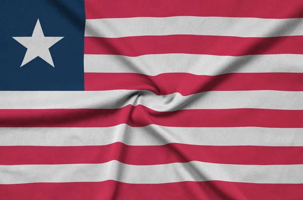 Liberia Flagge Ist Auf Einem Sportstoff Mit Vielen Falten Dargestellt — Stockfoto