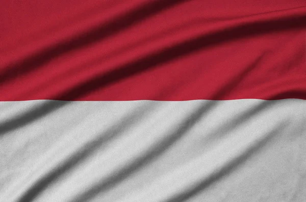 インドネシアの国旗は 多くのひだを持つスポーツの布生地に描かれています スポーツ チームを振ってバナー — ストック写真