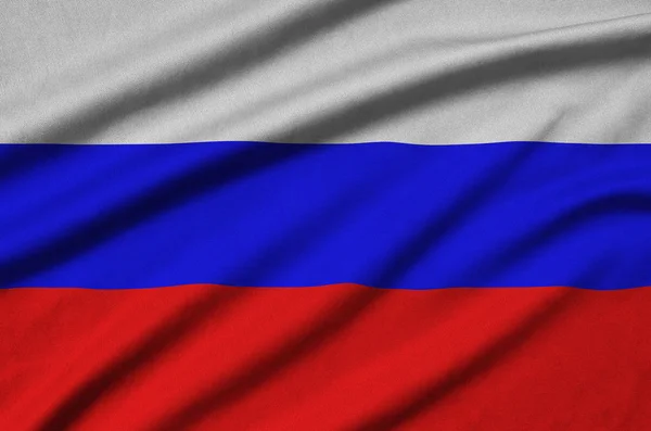 Russia flag  is depicted on a sports cloth fabric with many folds. Sport team waving banner