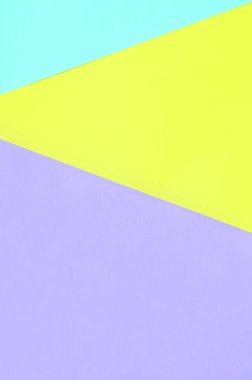 Doku arka planını moda pastel renkler. Mor, sarı ve mavi geometrik desen kağıtları. en az soyut.
