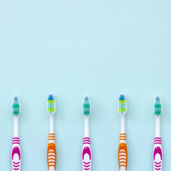 Lot Toothbrushes Lie Pastel Blue Background Top View Flat Lay — Stock Photo, Image