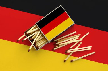 Almanya bayrağı bir kibrit kutusu içinden birkaç sonbahar eşleşir ve büyük bir bayrak üzerinde yatıyor açık gösterilir.