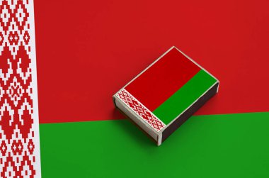Beyaz Rusya bayrağı üzerinde büyük bir bayrak yatıyor bir kibrit kutusu üzerinde resimde.