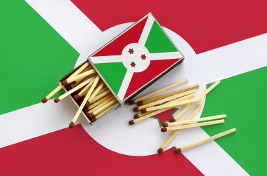 Burundi bayrağı bir kibrit kutusu içinden birkaç sonbahar eşleşir ve büyük bir bayrak üzerinde yatıyor açık gösterilir.