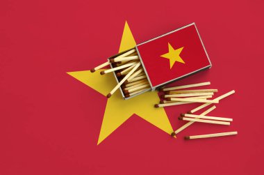 Vietnam bayrağı bir kibrit kutusu içinden birkaç sonbahar eşleşir ve büyük bir bayrak üzerinde yatıyor açık gösterilir.