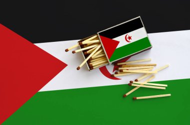 Batı Sahra bayrak bir kibrit kutusu içinden birkaç sonbahar eşleşir ve büyük bir bayrak üzerinde yatıyor açık gösterilir.