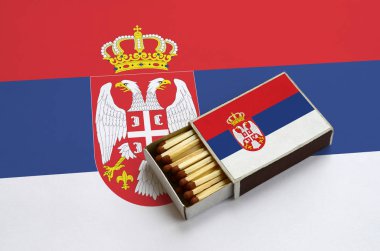 Sırbistan bayrağı açık bir kibrit kutusu içinde gösterilen hangi dolu maçlar ve büyük bir bayrak üzerinde yatıyor.