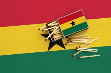 Gana bayrak bir kibrit kutusu içinden birkaç sonbahar eşleşir ve büyük bir bayrak üzerinde yatıyor açık gösterilir.