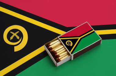 Vanuatu bayrağını açık bir kibrit kutusu içinde gösterilen hangi dolu maçlar ve büyük bir bayrak üzerinde yatıyor.