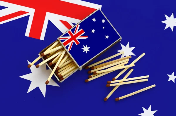 Avustralya bayrağı bir kibrit kutusu içinden birkaç sonbahar eşleşir ve büyük bir bayrak üzerinde yatıyor açık gösterilir.