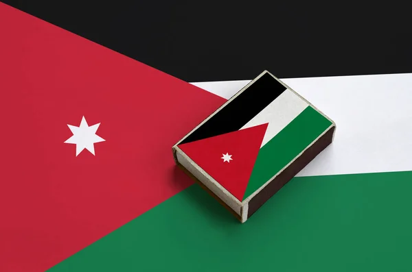 Jordan flag  is pictured on a matchbox that lies on a large flag.