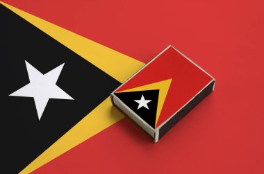 Timor Leste bayrağı üzerinde büyük bir bayrak yatıyor bir kibrit kutusu üzerinde resimde.