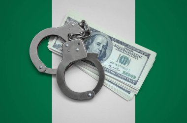 Nijerya bayrağı ile kelepçe ve a bohça-in dolar. Ülkenin para birimi bozulması. Mali suçlar.