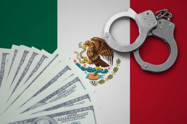 Mexico flag  with handcuffs and a bundle of dollars. The concept of illegal banking operations in US currency. clipart