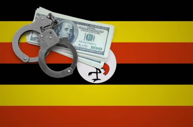 Uganda bayrağıyla kelepçe ve a bohça-in dolar. Hukuk ve hırsızlık suçları kırılma kavramı.