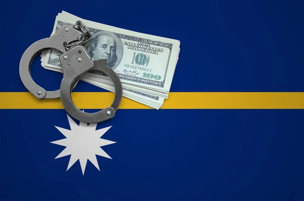 Nauru flag  with handcuffs and a bundle of dollars. The concept of breaking the law and thieves crimes.