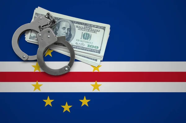 Cabo verde flag  with handcuffs and a bundle of dollars. The concept of breaking the law and thieves crimes.
