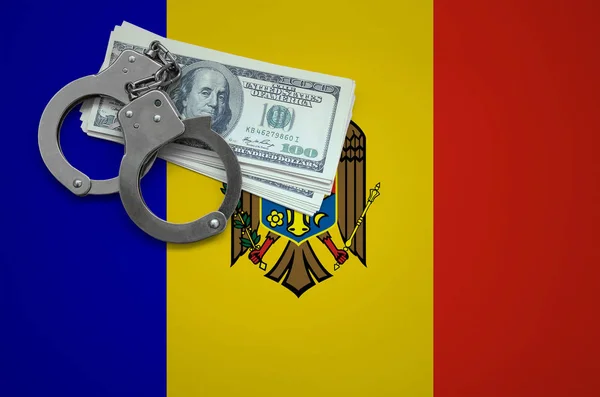 Moldova flag  with handcuffs and a bundle of dollars. The concept of breaking the law and thieves crimes.
