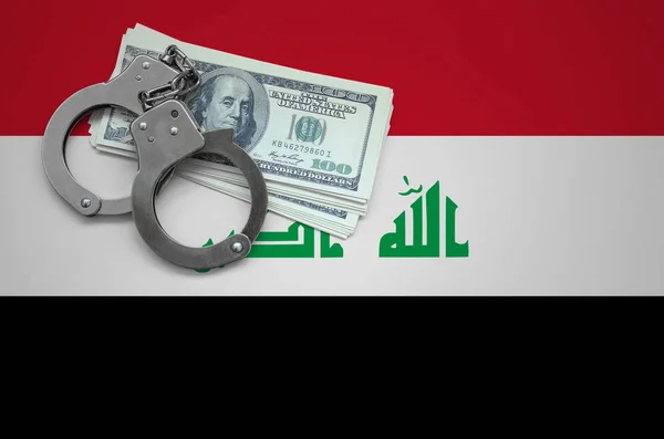 Iraq flag  with handcuffs and a bundle of dollars. The concept of breaking the law and thieves crimes.