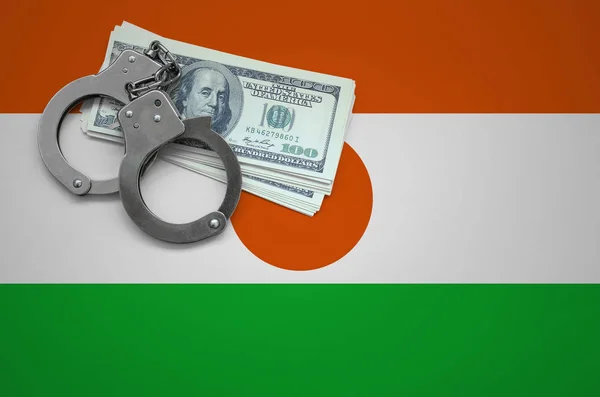 Niger flag  with handcuffs and a bundle of dollars. The concept of breaking the law and thieves crimes.