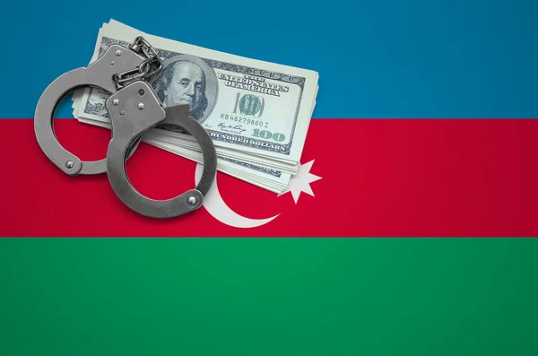 Azerbaijan flag  with handcuffs and a bundle of dollars. The concept of breaking the law and thieves crimes.