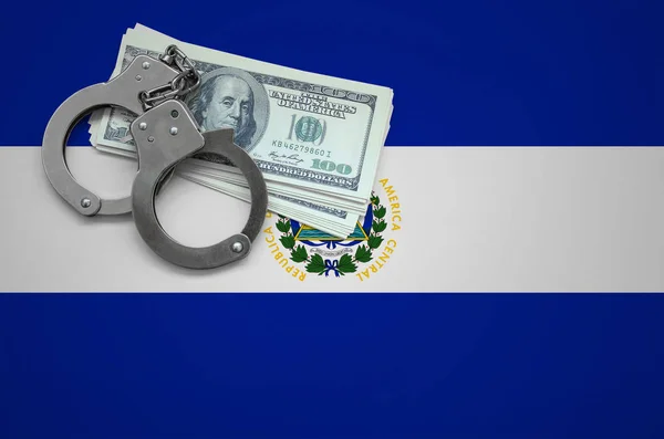 El Salvador flag  with handcuffs and a bundle of dollars. The concept of breaking the law and thieves crimes.