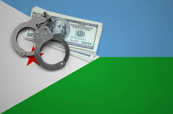 Djibouti flag  with handcuffs and a bundle of dollars. The concept of breaking the law and thieves crimes.