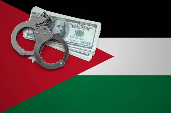 Jordan flag  with handcuffs and a bundle of dollars. The concept of breaking the law and thieves crimes.