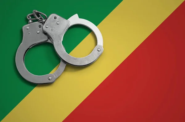 Congo flag  and police handcuffs. The concept of crime and offenses in the country.